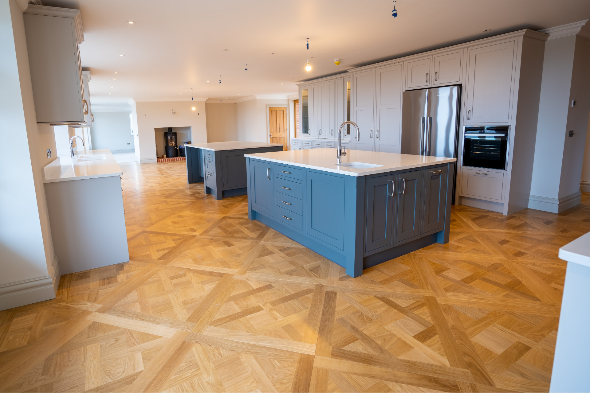 Beautiful herringbone parquet floor fitted in a spacious modern kitchen