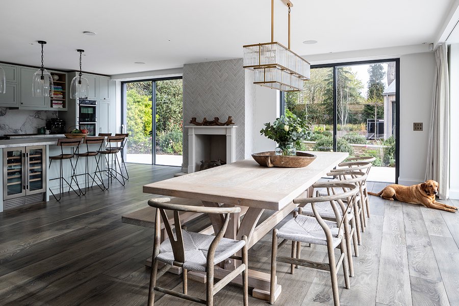 Stylish open-plan kitchen and dining room with dark wood flooring